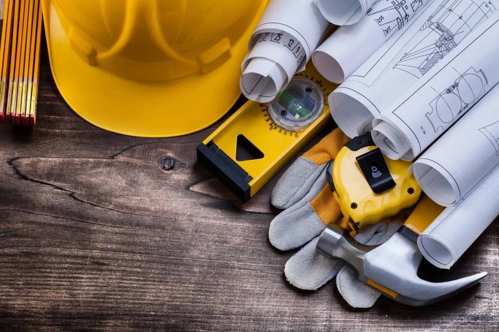 A yellow hard hat and some construction tools.